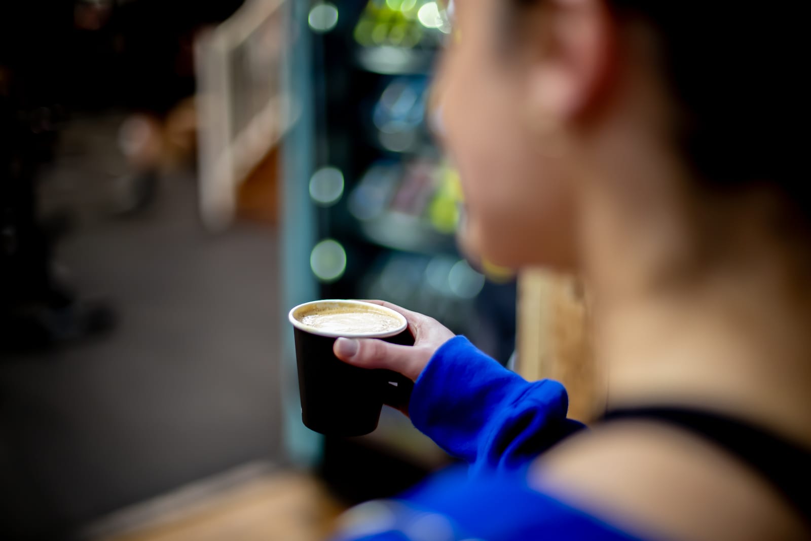 Customer with a coffee at The Bee Hive Cafe