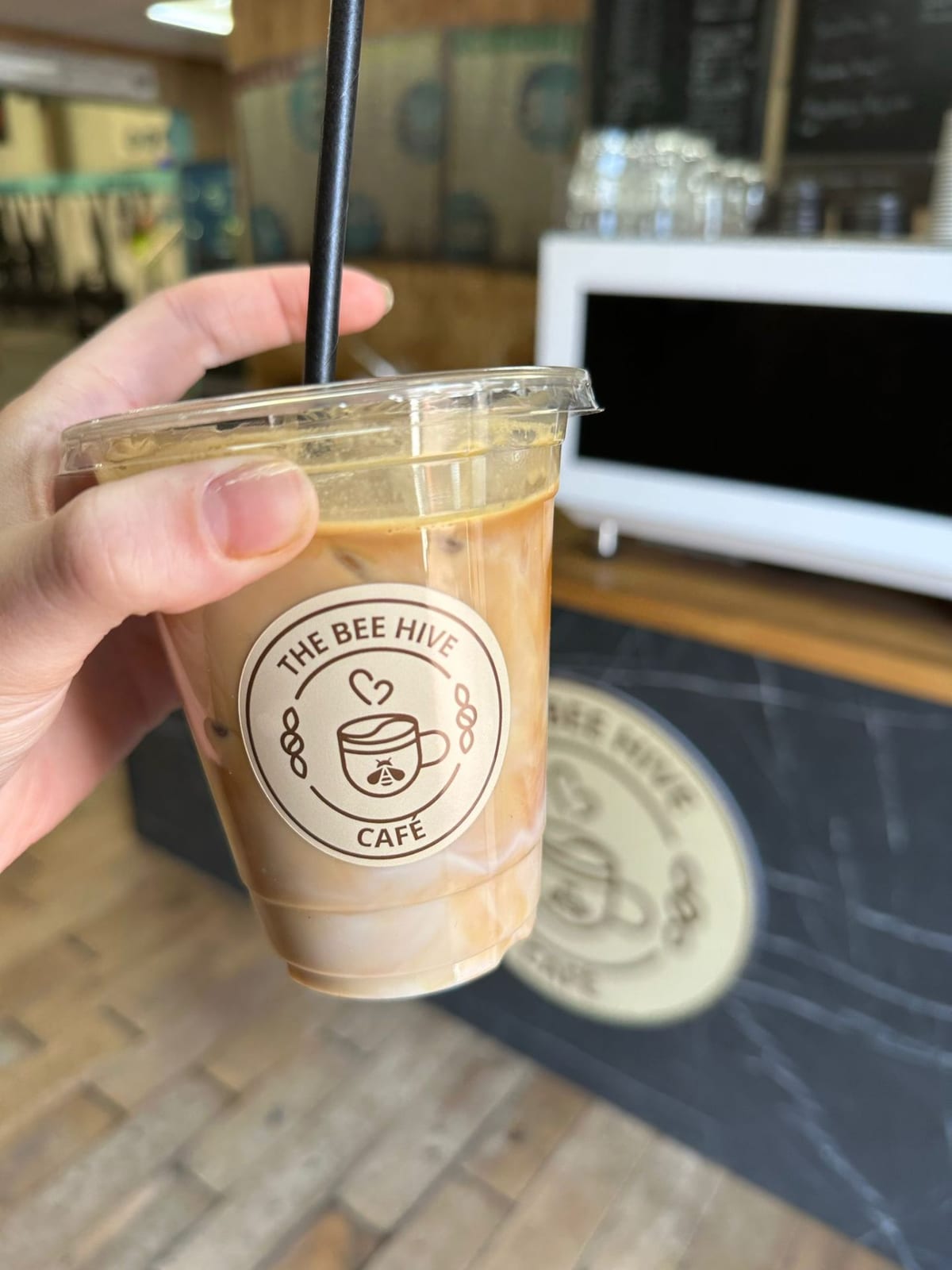 Iced latte in a Bee Hive Cafe cup